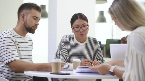 Colleagues Collaborating in Modern Office Environment