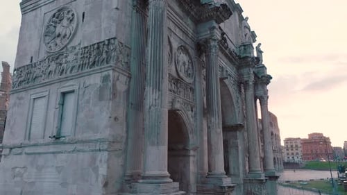 Aerial view around the Arco di constantino, revealing the Colosseum, in Rome, Italy - low, orbit,