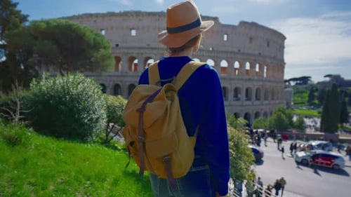 Young Adult Tourist Visits Colosseum in Rome