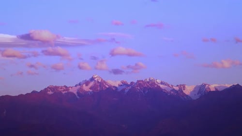 Timelapse of Mountain Landscape with Clouds Moving Fast Above the Peaks and Approaching Dusk