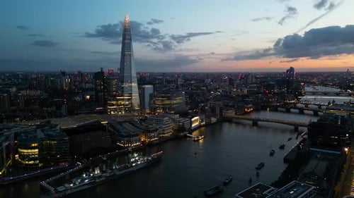 Night aerial shot of The Shard building and Thames river, London, United Kingdom
