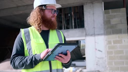 Happy with progress on construction site using digital tablet senior inspector engineer taking notes