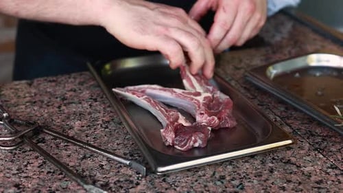 Chef Prepares Raw Rib Chops
