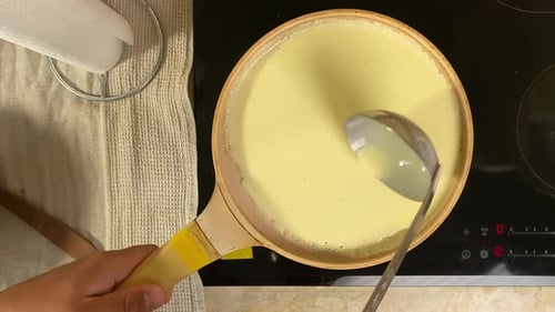 Pouring Pancake Batter into a Frying Pan