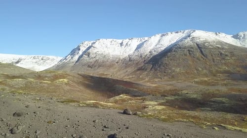Landscape with Mountains Covered By Snow Under Cloudy Sky in Iceland