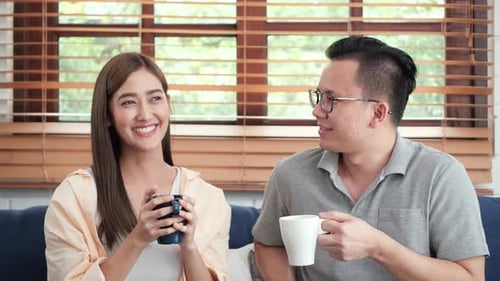 Couple Chatting and Drinking Coffee Indoors