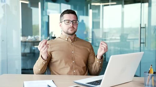 Man Meditating at Office Desk During the Day