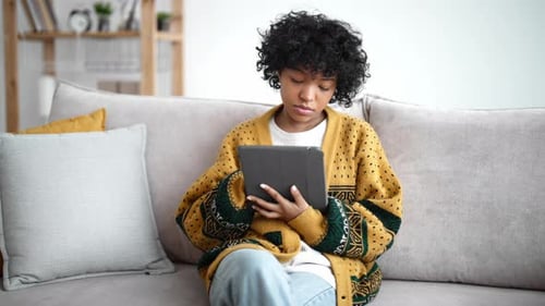 Young Woman Using Tablet Device at Home