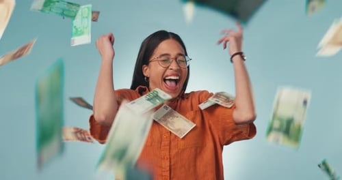 Happy woman, money rain and celebration for winning, lottery or prize against a studio background