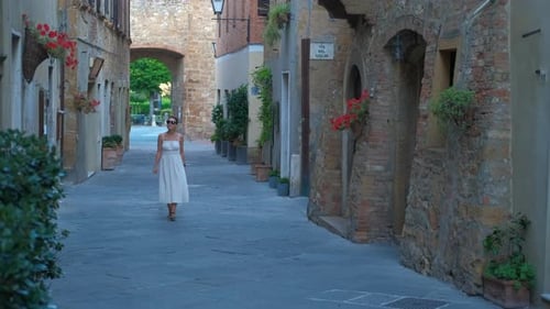 Woman in White Dress Exploring Ancient Italian Town