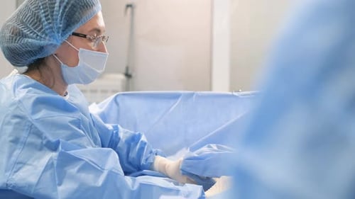 A Team of Surgeons During an Operation to Remove Leg Veins Using Surgical Laparoscopy Instruments