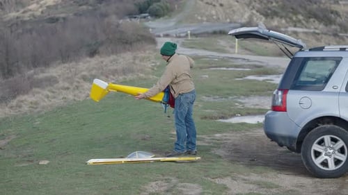 A Man Takes Apart the Parts of His Toy Plane