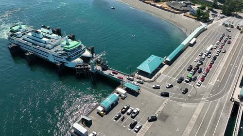 Orbiting aerial shot of cars loading onto the Clinton ferry on Whidbey Island.