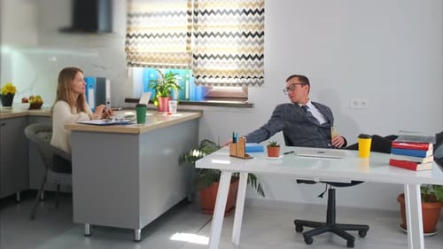 Relaxed Boss Over Desk White Boss Unwinding Amid Scattered Papers Casual Boss Lying Back in Bright