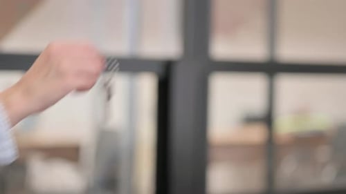 Female Real Estate Agent Giving Home Keys to Businessman, Close Up