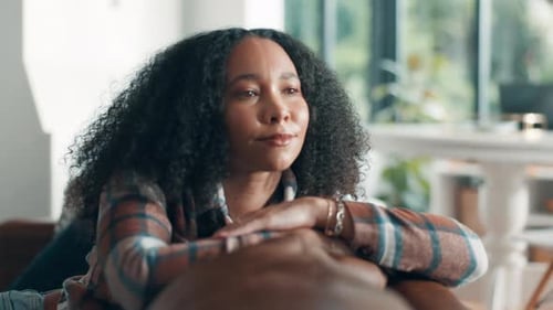 Woman Resting on Man's Arm in Bright Home