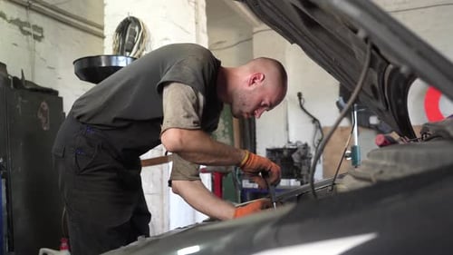 auto mechanic repairs car engine. auto repair shop. diagnostics