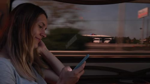 Woman Using Cellphone While Riding a Vehicle at Night