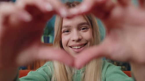 Woman Making Heart Shape With Hands