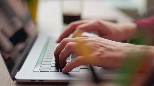 Close Up of Freelancer's Developer Hands Typing Program Code on Laptop Keyboard in Coworking