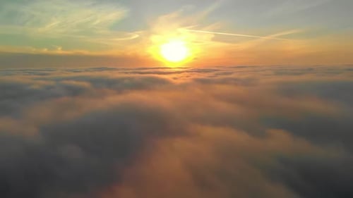 Aerial Jib Up of Sun Over Soft Clouds
