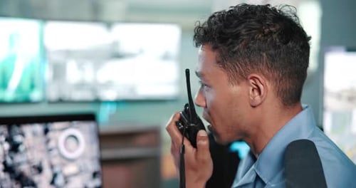 Security guard, man and discussion with radio in office for surveillance, feedback or crime watch