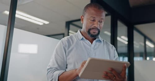 Man Using Tablet in Modern Office Building