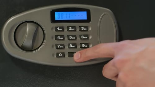 Hand Entering Security Code on Digital Safe