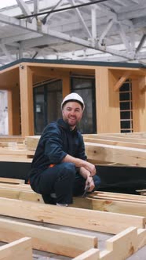 Male worker is in the modern warehouse or manufacturing company.