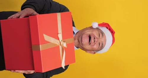 Smiling Man Holding Christmas Gift