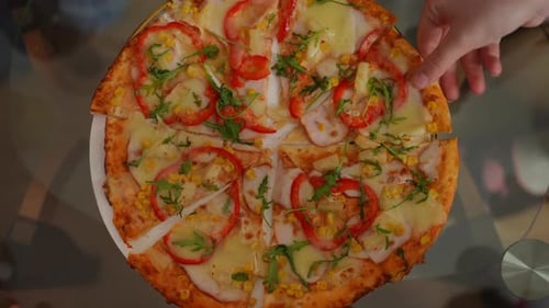 Closeup Top View Delicious Pizza on Table with Male and Female Hands Taking Pieces Leaving Closeup