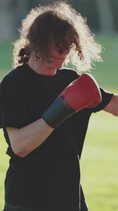 Boxer Training with Punches in Park