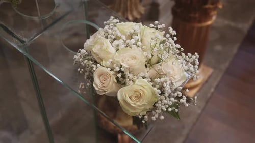 Wedding Bouquet with White Roses on Glass Table