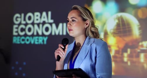 Woman Speaking at a Corporate Event about Global Economy