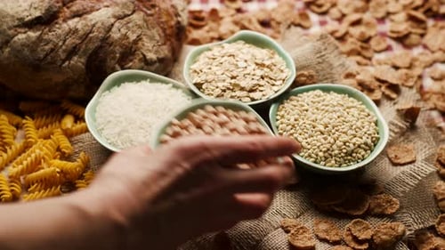 Hand Placing Bowl with Carbs Food on Table