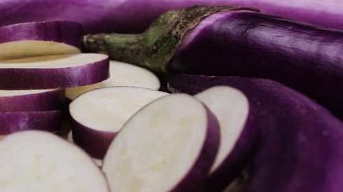 Cutting Slice of a Violet Eggplant is Placed on a Wooden Cutting Board Showcasing the Beauty of This