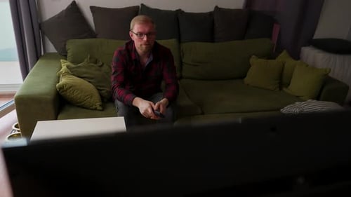 Man Watching TV on Couch at Home