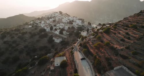 Aerial view of white buildings on hillside, Greece.