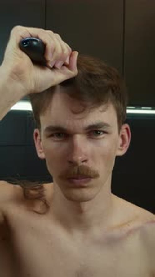 Man Cutting His Own Hair with Electric Razor
