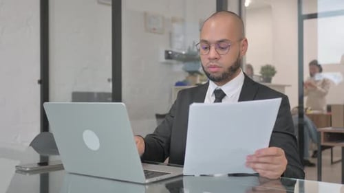 Professional Man Working at Laptop in Modern Office