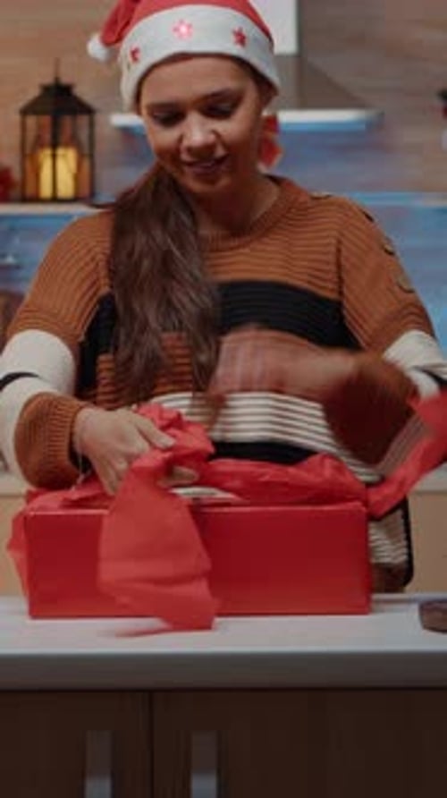 Vertical Video Festive Woman Preparing Gifts with Wrapping Paper