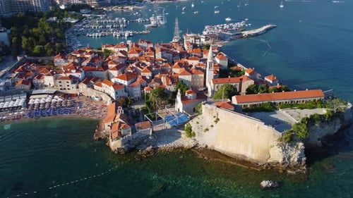 Aerial drone rotating view of Budva old medieval town and citadel in Montenegro