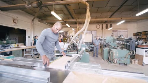 Professional Carpenter Measuring Wood on a Table Saw