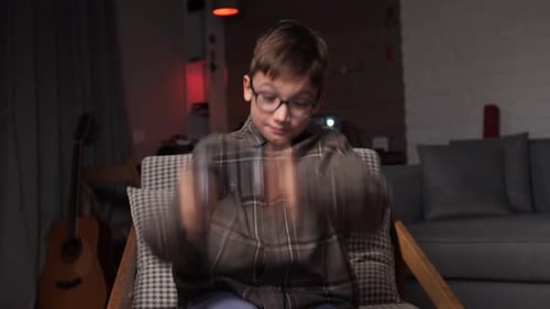 Enthusiastic Boy Plays Video Game Indoors