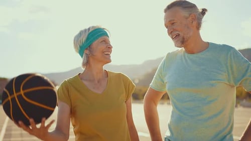 Senior Couple Playing Basketball in Urban Setting