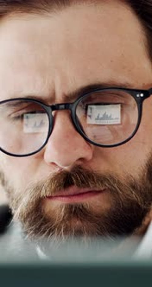 Glasses, graph and business man on computer for financial review, profit growth and investment