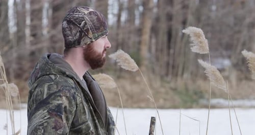 Man with beard and camo in snowy reeds