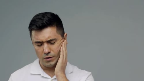 People, Healthcare, Dentistry And Problem Concept - Unhappy Man Suffering From Toothache Over Gra...