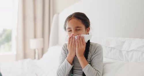 Girl with Cold Blowing Nose in Bed