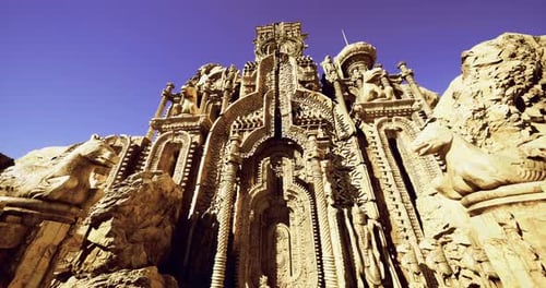 Intricate Stone Carvings at a Historic Structure Under Clear Blue Sky